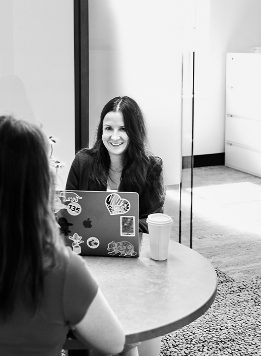 Employee smiling at laptop