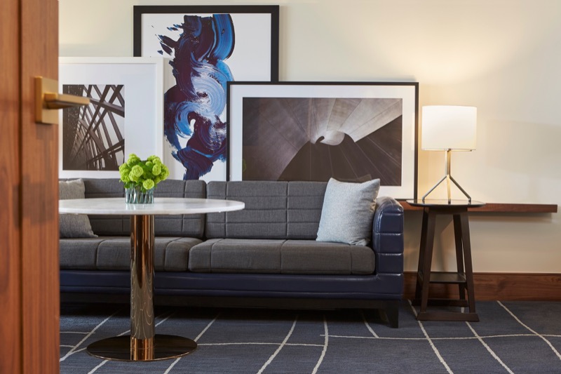 Couch, coffee, table and paintings hanging on the wall