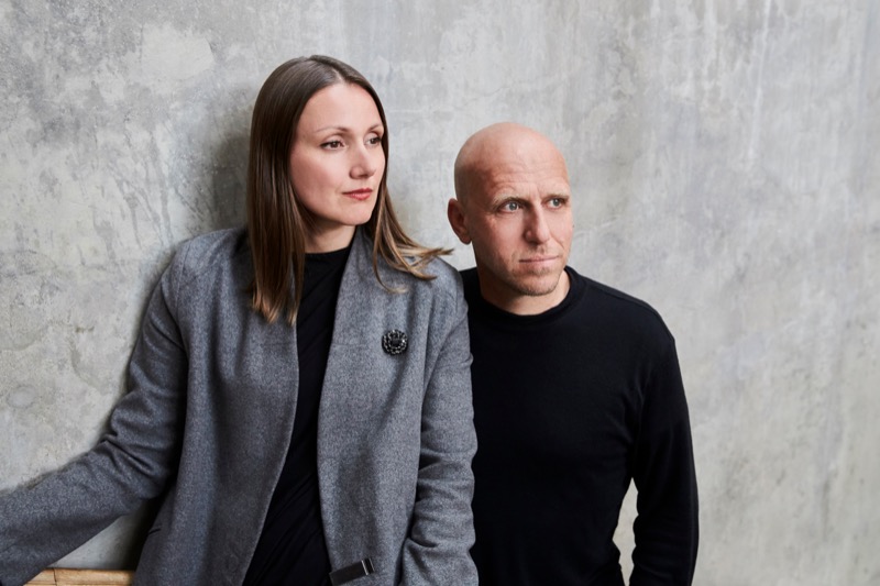 Sharply dressed man and woman looking off camera