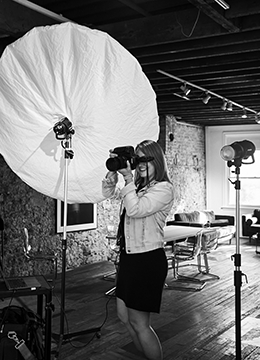 Smiling woman holding camera and taking a photo